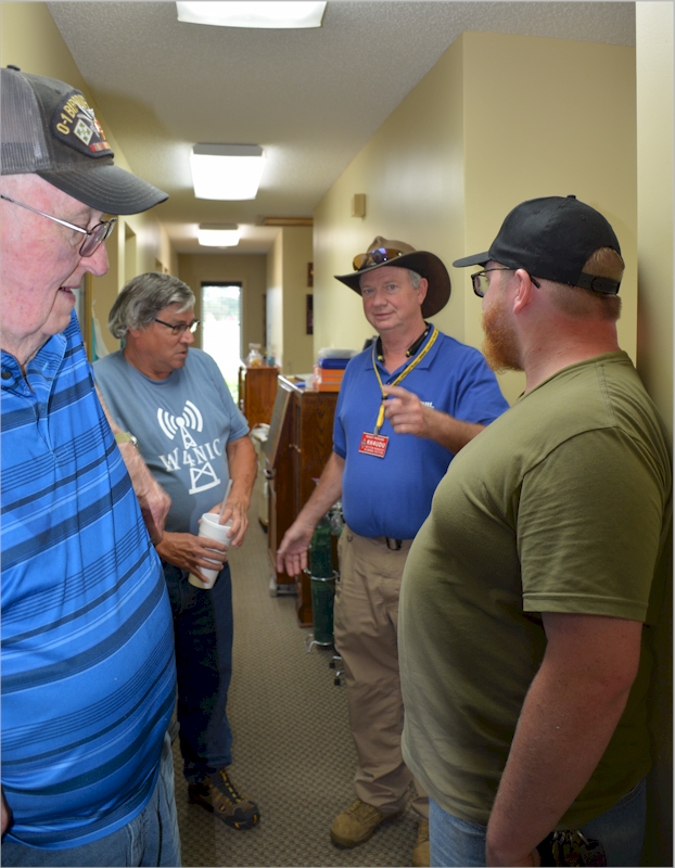 Jerry WB4OWC, Barry W4NIC, and Bradley KO4RQS listen to Roger Parsons KK4UDU, ARRL Section Manager for Alabama.