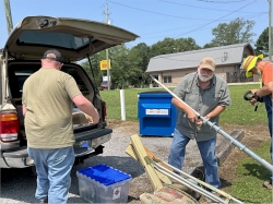 Bradley KO4RQS, Glenn KE4YZK and Bob KE4QCY unloading gear from Bradley's Treasure Truck