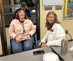 KM4DII Lee Ann and KF4OAX Dale share a laugh while WB4OWC Jerry photobombs.